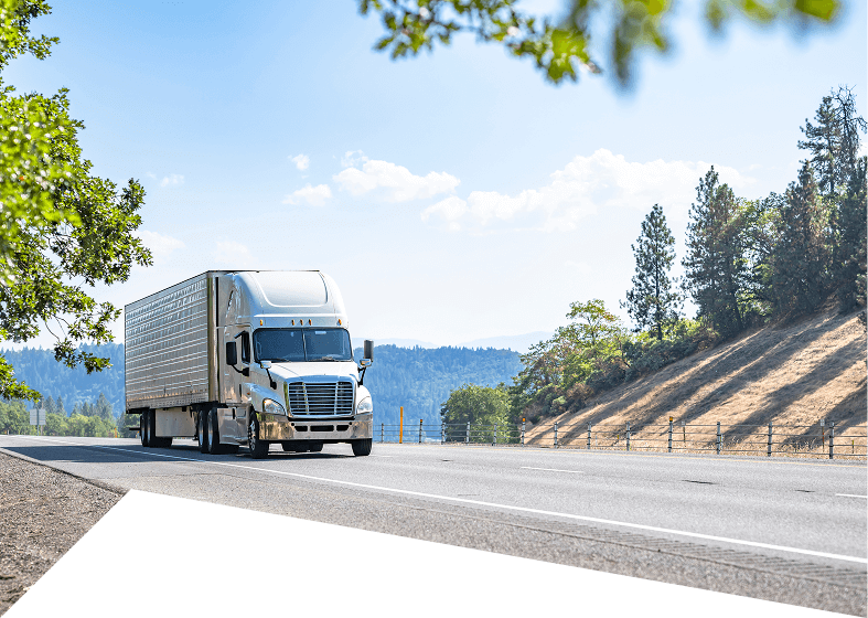Truck driving on a scenic highway.